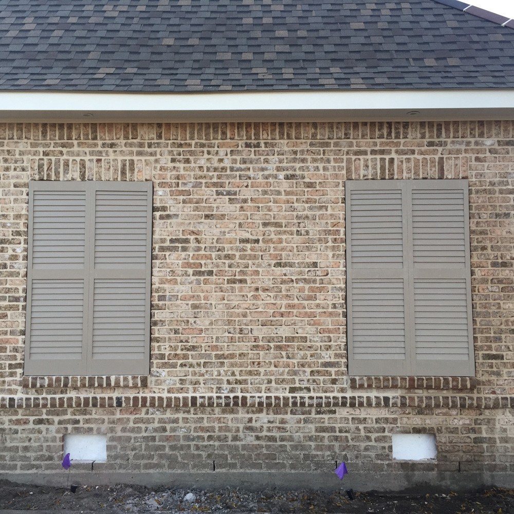 Shutters on brown brick home - Strong Shield 