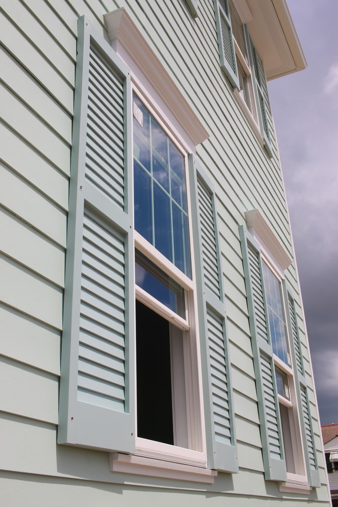 Shutters on home with green siding - Strong Shield