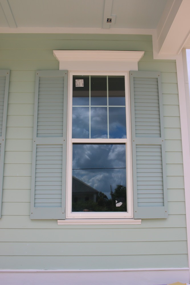 Shutters on light green New Orleans home - Strong Shield