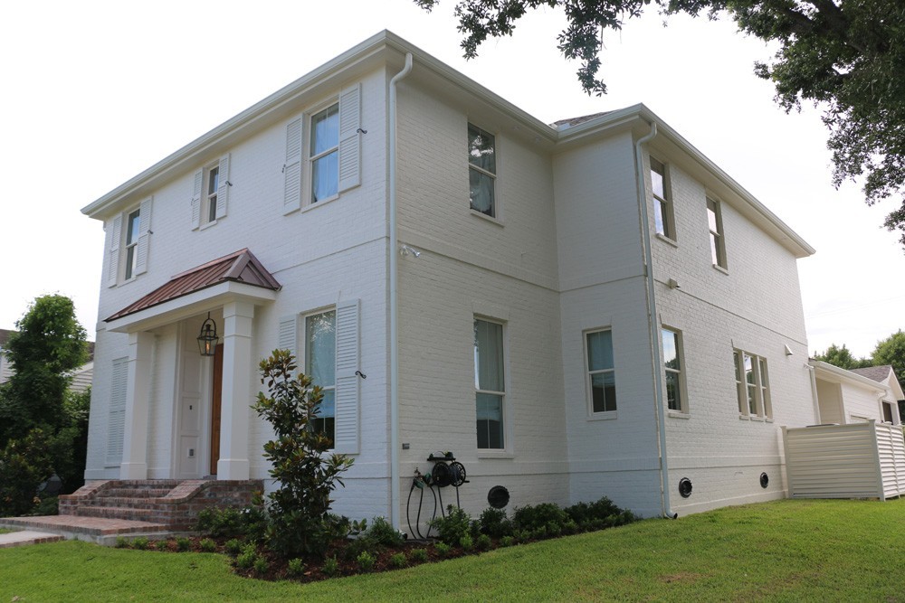 White shutters on white New Orleans home - Strong shield