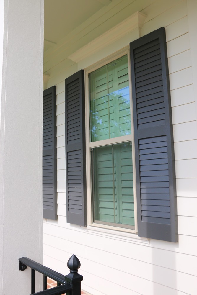 Shutters on New Orleans home with white hardie siding - Strong Shield