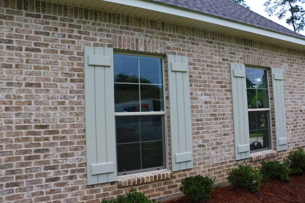 Light colored board and batten shutters - Strong Shield