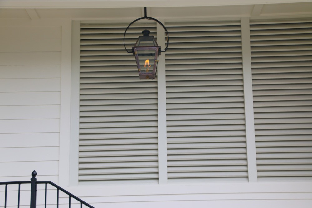 Louvered style shutters on front porch - Strong Shield