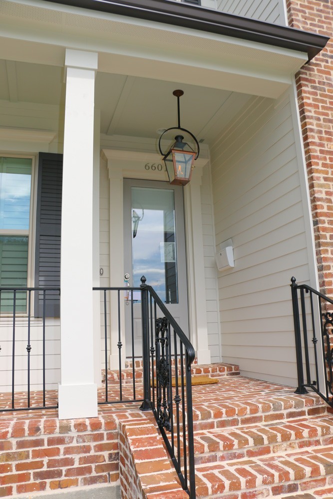 Iron railing, craftsman columns and trim on Metairie home - Strong Shield