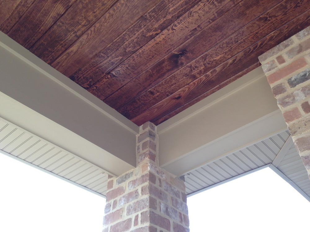 Wood porch ceiling with white trim and brick columns - Strong Shield