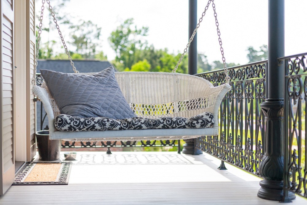 New Orleans porch with swing and iron railing - Strong Shield