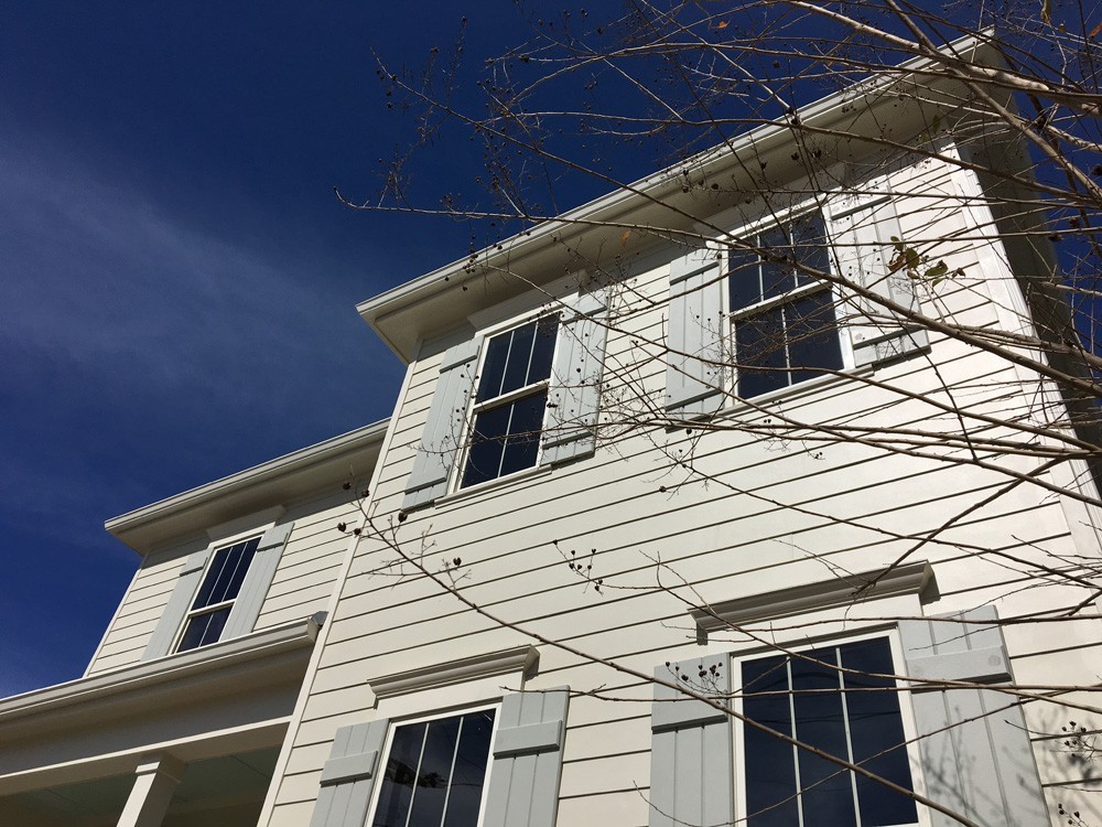 Custom wood shutters on two story home - Strong Shield