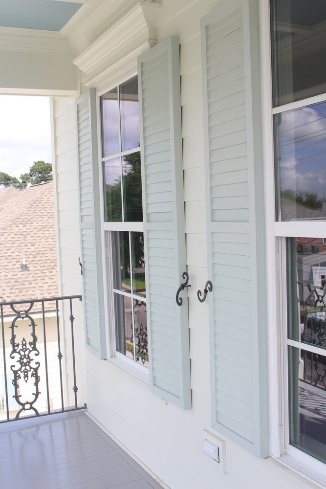 Light green shutters on white home - Strong Shield