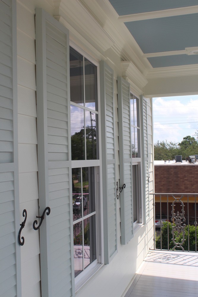 Shutters with wrought iron holdbacks - Strong Shield