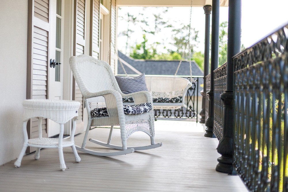 Tan shutters on light colored porch - Strong Shield