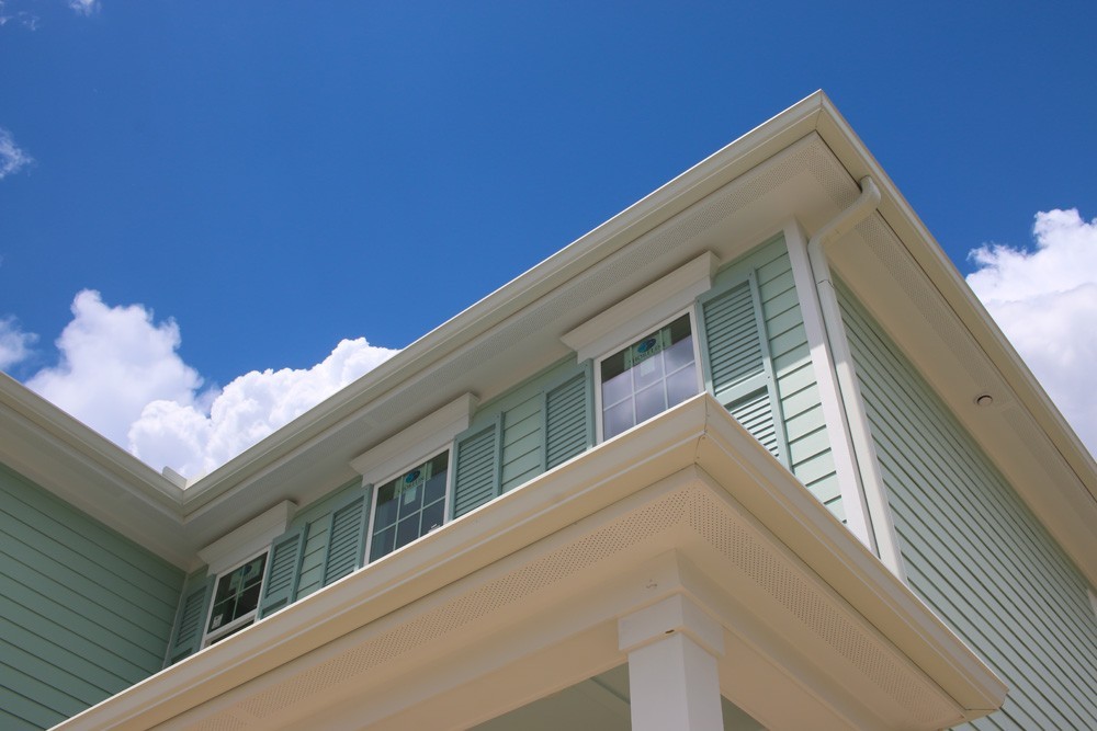 Green shutters on green two story home - Strong Shield