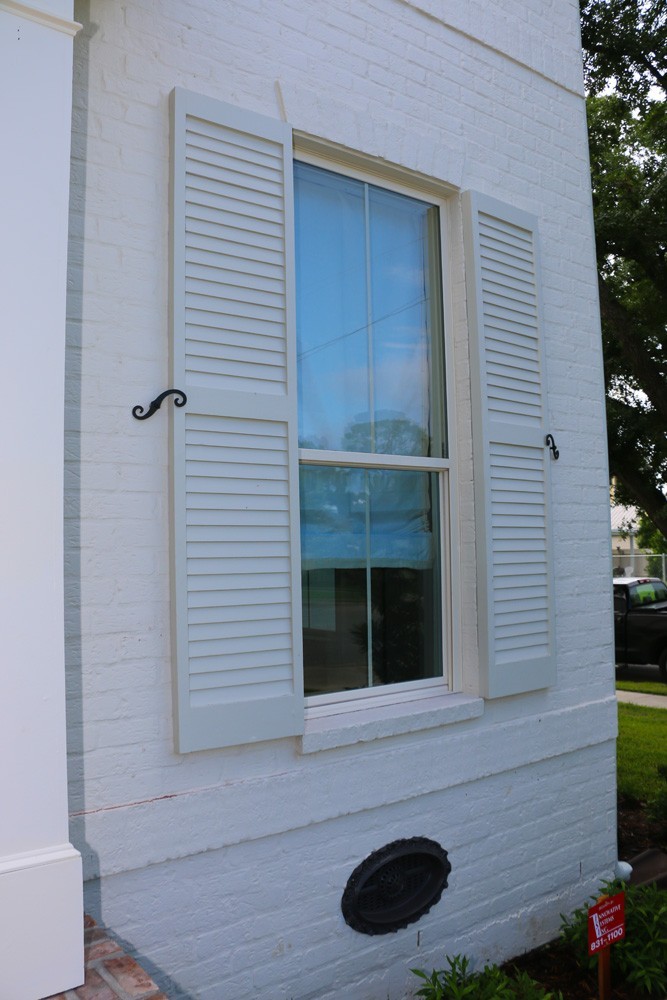 White shutters on white New Orleans home - Strong Shield