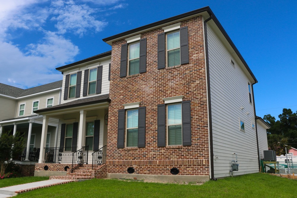 Shutters for red brick two story home - Strong Shield