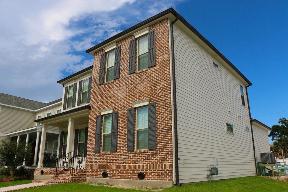 Shutters on two story brick and siding home - Strong Shield