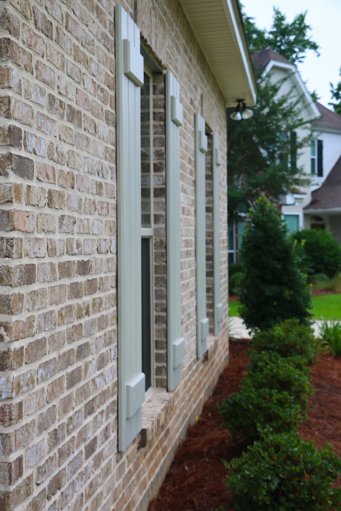 Board and batten style shutters on home - Strong Shield