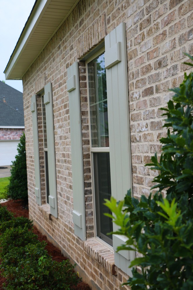 Tan brick and sage shutters - Strong Shield