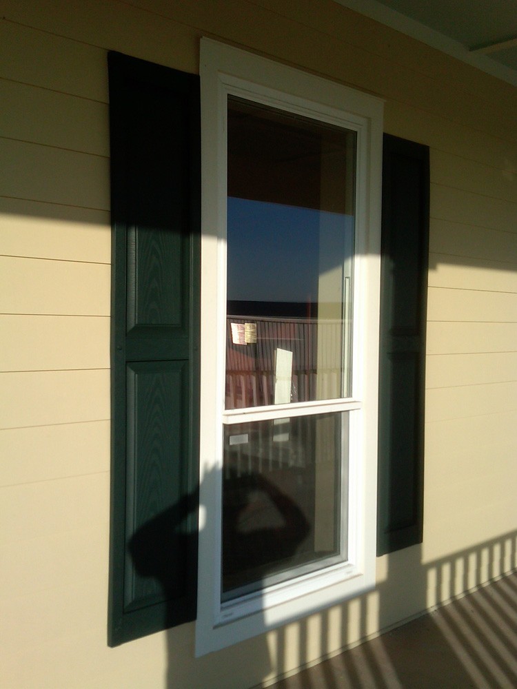 Dark raised panel shutters on hardie siding - Strong Shield