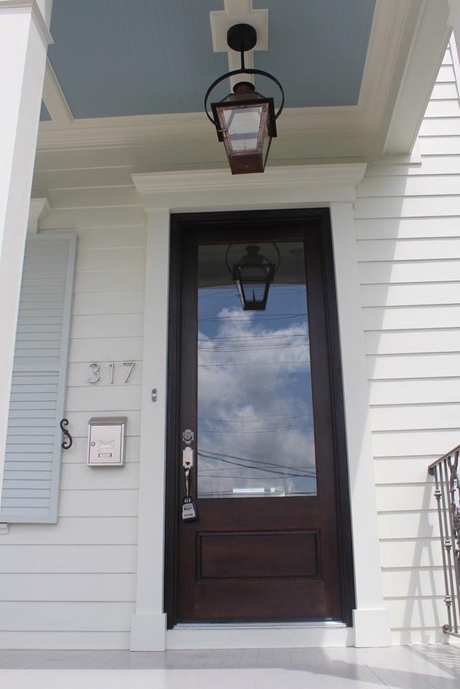 White craftsman trim around dark wood door - Strong Shield