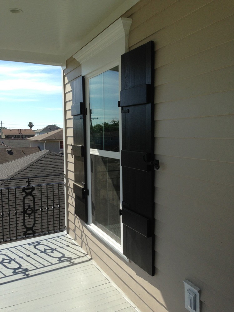 Black board and batten shutters with craftsman trim above window - Strong Shield