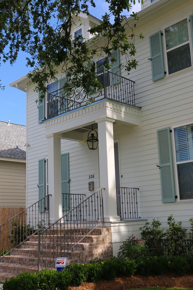 Iron railing, large craftsman columns, dentil molding - Strong Shield